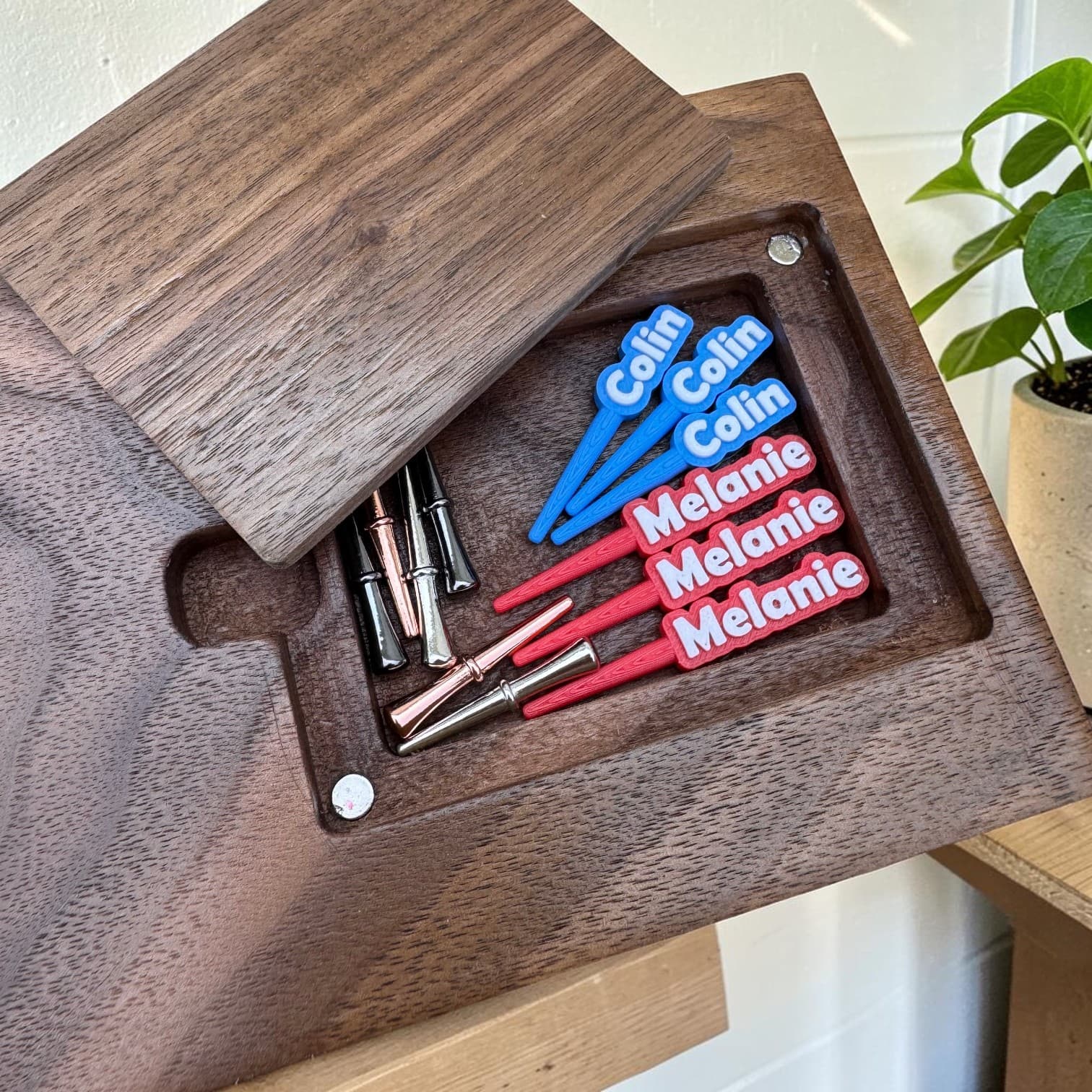 Hidden back-pocket peg storage on the underside of a cribbage board